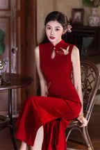 Wine red qipao seated, showing how the side slit opens