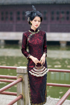 Wine red cheongsam dress showing the full-length sleeves and close fit