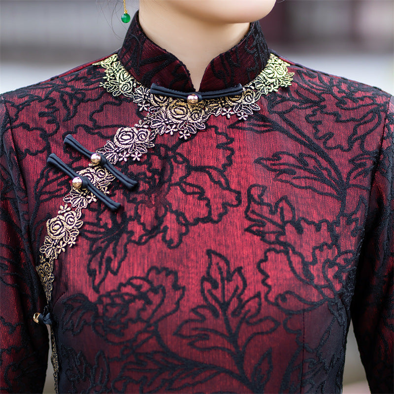Mandarin collar and gold piped trim on the wine red cheongsam