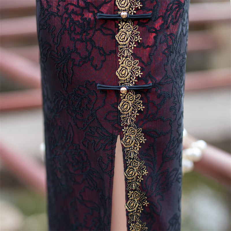 Gold piped placket and side slit of the wine red cheongsam