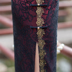 Gold piped placket and side slit of the wine red cheongsam