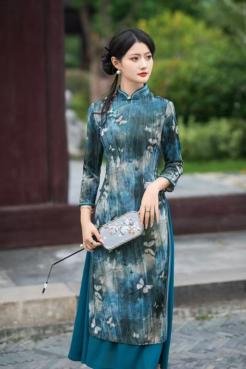 Full-length view of the teal butterfly velvet ao dai-inspired dress