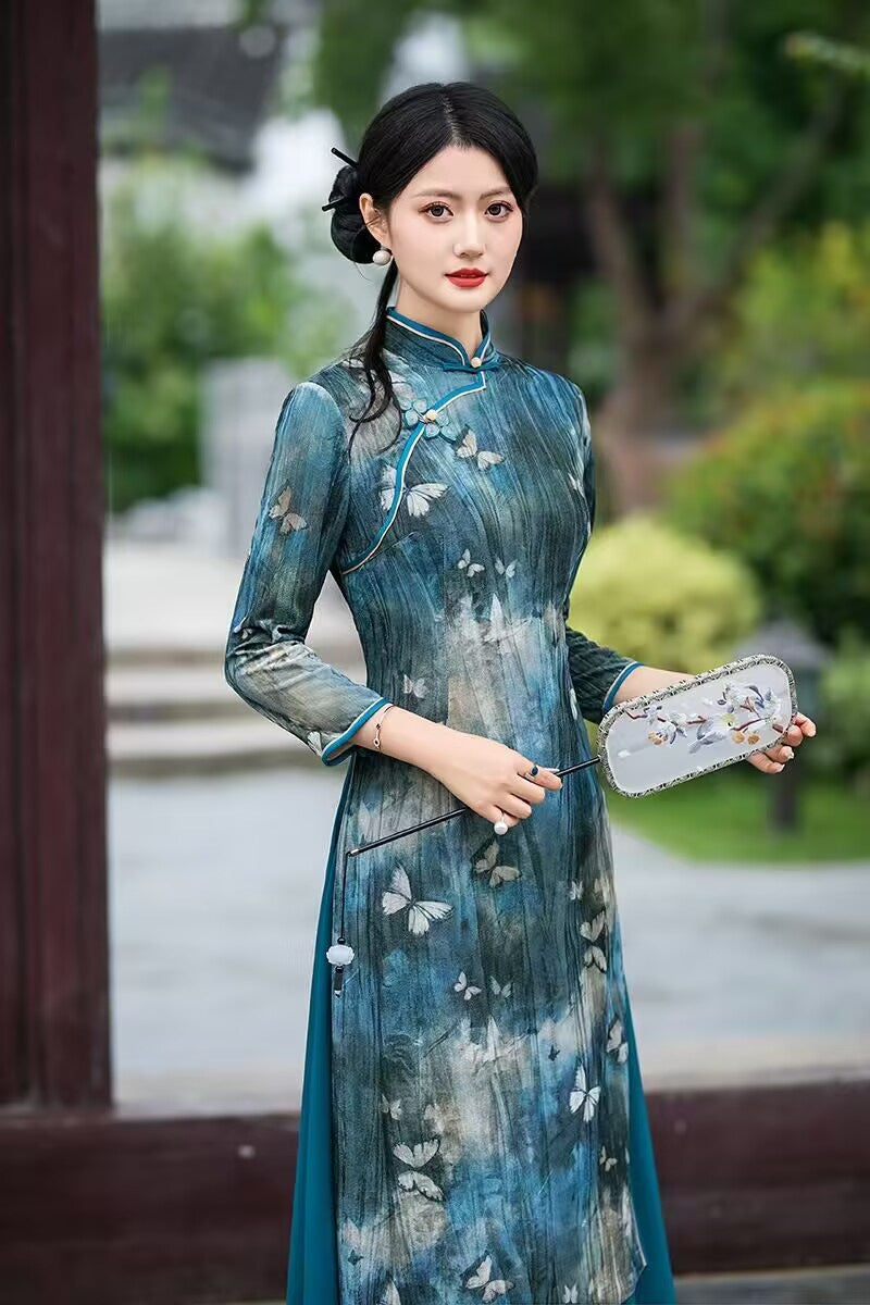 Teal velvet qipao dress showing the mandarin collar and diagonal frog-button front