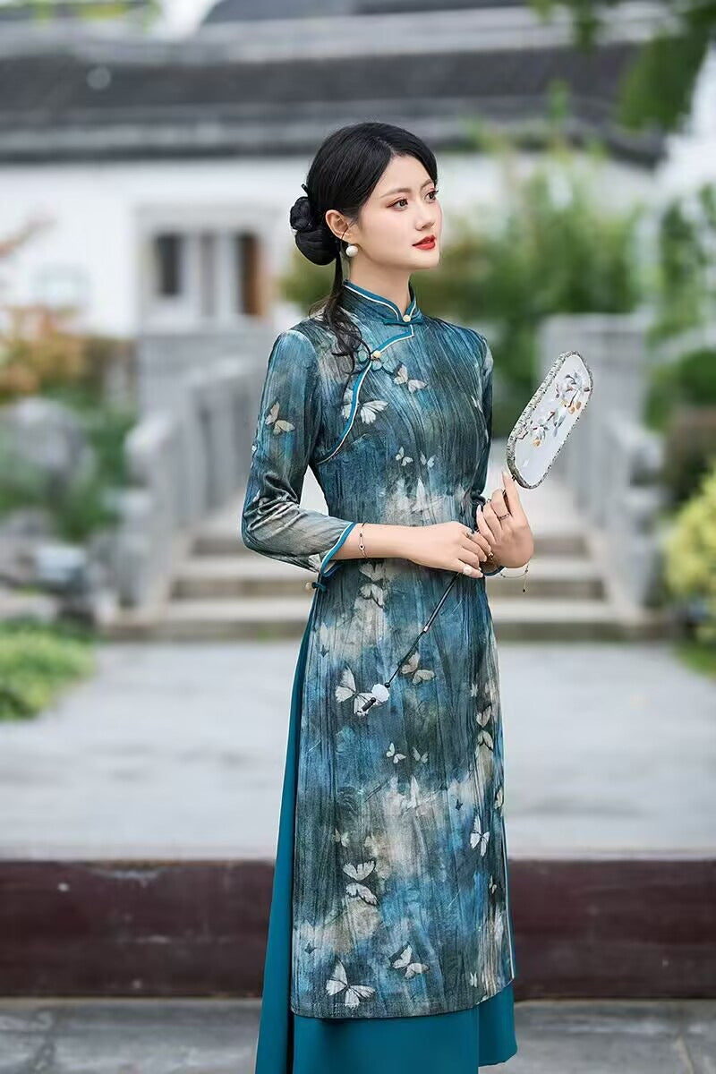 Teal velvet ao dai-inspired qipao dress worn with the skirt layer