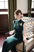 Three-quarter view of the deep green crane embroidered cheongsam