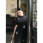 Black butterfly embroidered qipao dress, three-quarter view