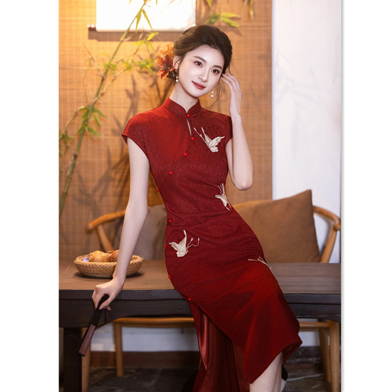 Full-length red crane qipao showing the side slit